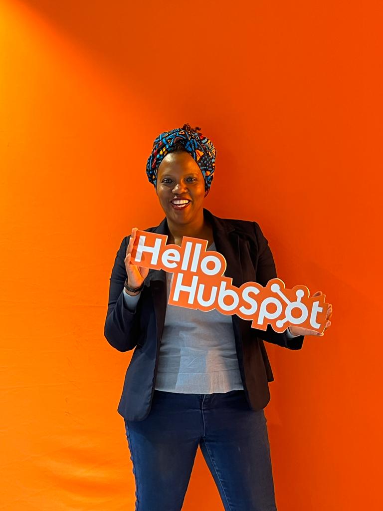 Resa Gooding holding a Hello HubSpot sign at HubSpot